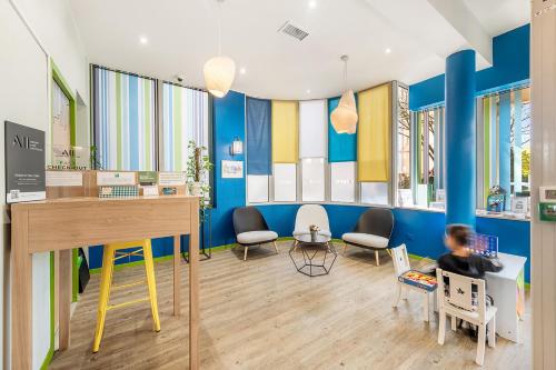 a childrens waiting room with blue walls and chairs at Ibis Styles Lyon Croix Rousse in Lyon