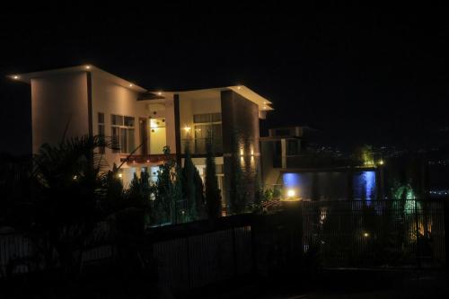 a house at night with lights in front of it at LUMI R Boutique Hotel in Kigali
