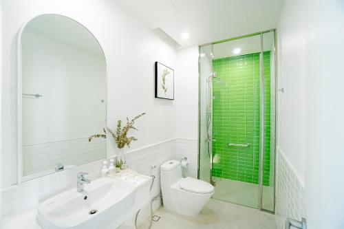a bathroom with a toilet and a sink and a shower at Sole Casa Phu Quoc in Phu Quoc