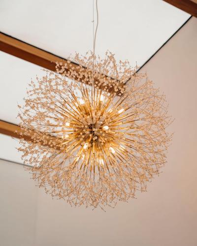 a chandelier is hanging from a ceiling at LUMI R Boutique Hotel in Kigali