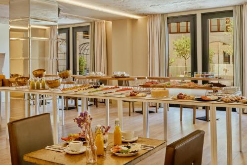 a restaurant with tables with food on them at Pamplona Catedral Hotel in Pamplona