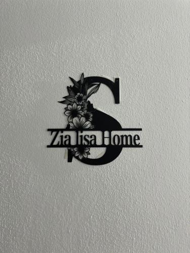 a black and white logo with a letter b and flowers at Zia Lisa Home in CTA