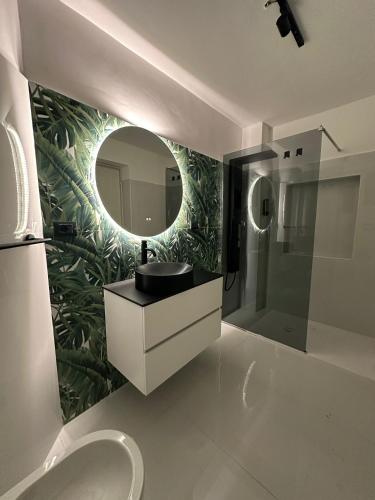 a bathroom with a sink and a mirror at Zia Lisa Home in CTA