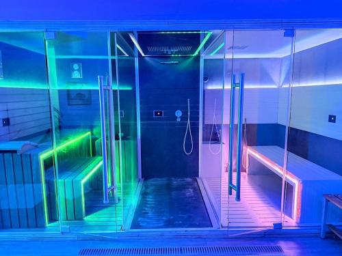 Un baño con ducha con luces de colores. en Luxury Villa in Spello, Private Pool, Spa, Restaurant, sleeps 54 inc 18 children, en Spello
