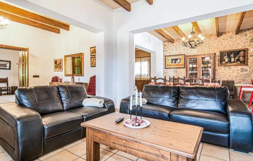 a living room with leather couches and a table at Cas Cuni in Felanitx