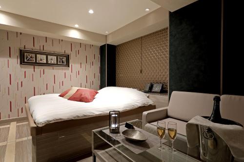 Una cama o camas en una habitación de Hotel Valentine Chiryu