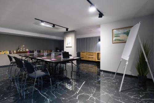a conference room with a long table and chairs at Amarant Urban Hotel by CHM in Kyiv