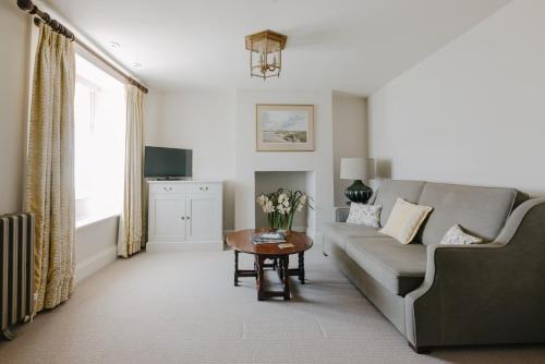a living room with a couch and a table at Victoria in Holkham