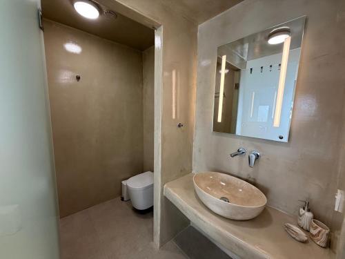 a bathroom with a sink and a toilet at Dival Properties Mykonos 1 & 2 in Megali Ammos