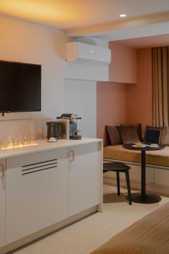 a living room with a couch and a table with a laptop at MiHotel - Rue Cuvier in Lyon