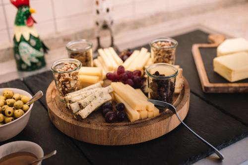 a tray of cheese and other foods on a table at HENRI Country House Kitzbühel in Kitzbühel