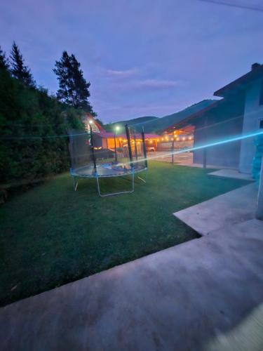 a yard with a gazebo in the grass at night at Casa Delia in Slănic-Moldova