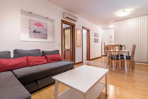 a living room with a couch and a table at AVE Apartamentos Madrid Centro Atocha in Madrid