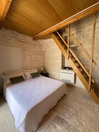een slaapkamer met een groot bed met een houten plafond bij Nidus Petrae in Alberobello