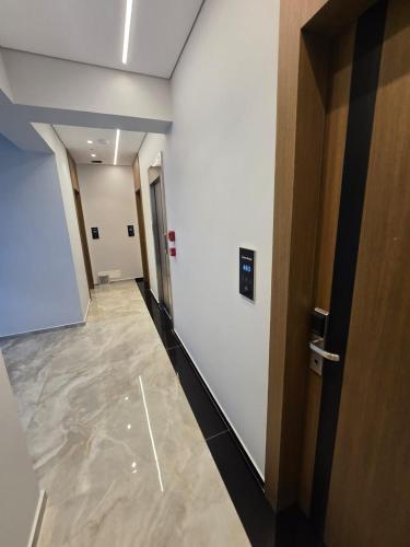 a hallway of an office building with a door at Hotel Selavi in Sarandë