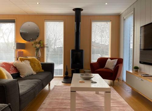 a living room with a couch and a fireplace at The Sleights, Strawberryfield Park - Hot Tub - Free WiFi & Parking - Pets Allowed 2 in Cheddar