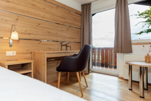a room with wooden walls and a chair and a table at Ferienwohnung AUSZEIT mit Wellnessnutzung in Ainring
