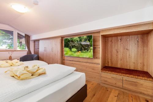 two beds in a room with wood paneling at Ferienwohnung AUSZEIT mit Wellnessnutzung in Ainring