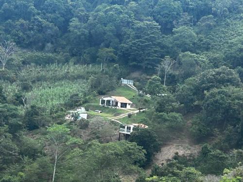 a house on a hill in the middle of a forest at Entre Nubes in Nocaima