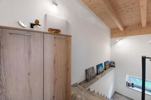 a wooden cabinet in a room with a wooden ceiling at La Villa di Ludo in San Cassiano