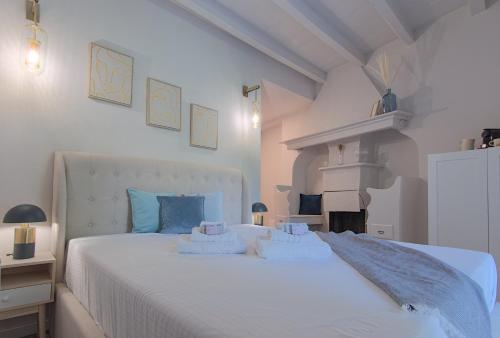 a bedroom with a white bed with two pillows on it at Lario Nest - The Suites in Mandello del Lario