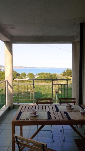 a large wooden table on a balcony with a view at Sea View in Topola