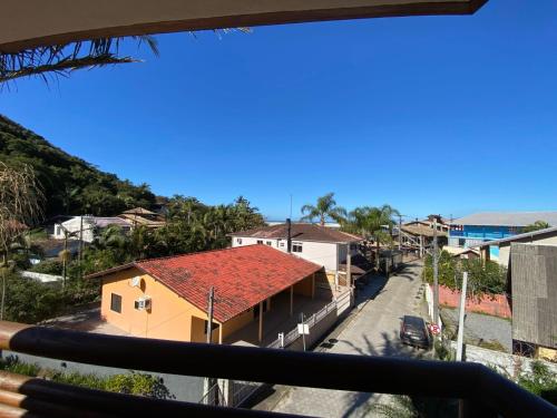 a view from the balcony of a house with a red roof at Pousada Ondas do Embaú in Palhoça