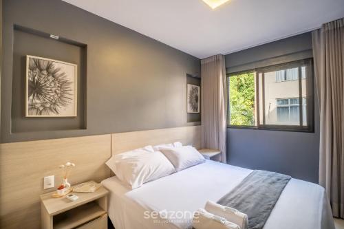a bedroom with a bed and a window at Apart in Condo w/ Pool and Gym STE0312 in Salvador