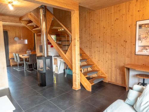 a wooden staircase in a room with a table at Woody Park Feriendorf Murau in Murau