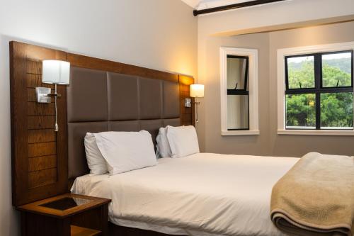 a hotel room with two beds and a window at Premier Resort Mpongo Private Game Reserve in Macleantown