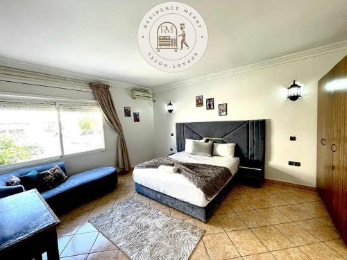 a bedroom with a bed and a couch at Merry Studio Hotel in Agadir