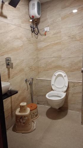 a bathroom with a toilet and a sink at Hotel VOLGA INN in Ahmedabad