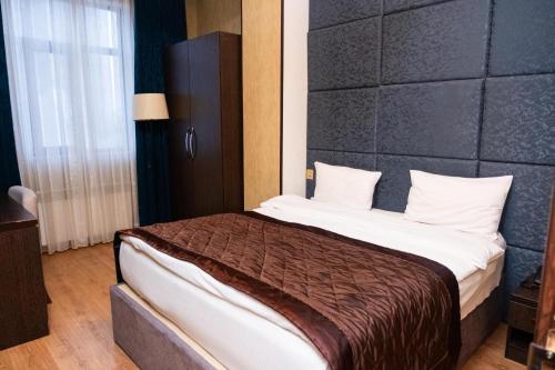 a bedroom with a large bed in a room at Grand Boutique Hotel in Baku