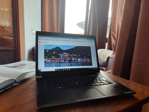 a laptop computer sitting on top of a wooden table at Casa Clod in Menaggio