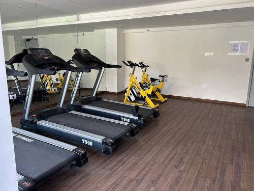 a gym with several exercise bikes in a room at Sparsh A Luxury Experience by Stay Haven in Pune