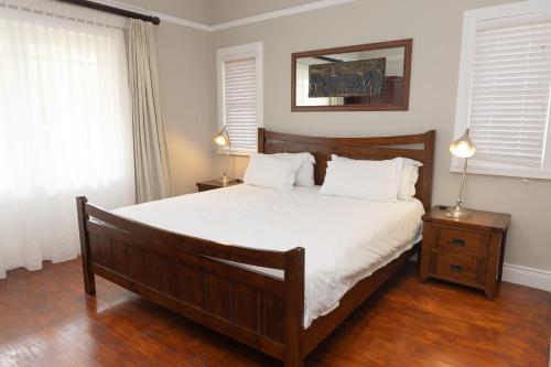 a bedroom with a large bed with white sheets and white pillows at Premier Resort Mpongo Private Game Reserve in Macleantown