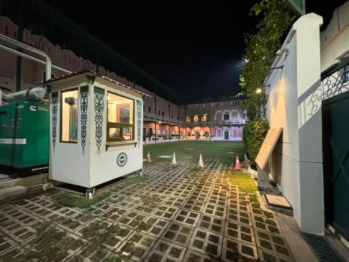 a small house is sitting on a courtyard at night at Hotel Pradeep in Varanasi