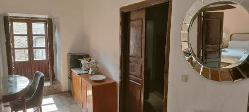 a room with a mirror and a table and a bed at 85 Teclas in Puebla de Sanabria