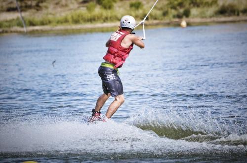 a man is water skiing on a lake at LA PROVENCE fantastic apartment 75m2 Big pool private parking top location in Le Pontet