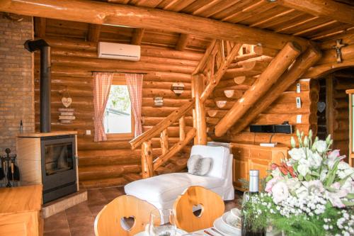 a log cabin with a living room with wooden walls at Cabin Noah in Novi Marof