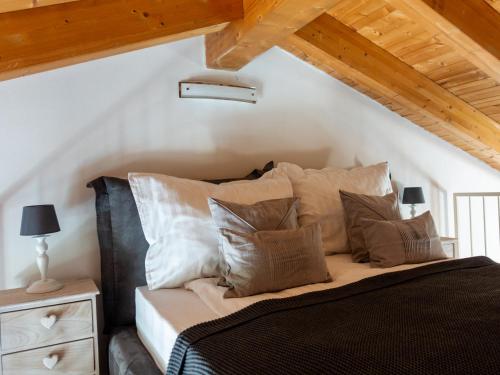 a bedroom with a bed with pillows at Sogno sul Fiume in Sovere