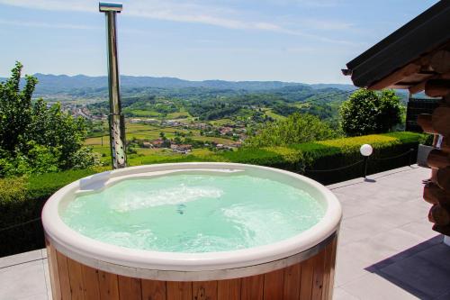 a jacuzzi tub on a patio with a view at Cabin Noah in Novi Marof