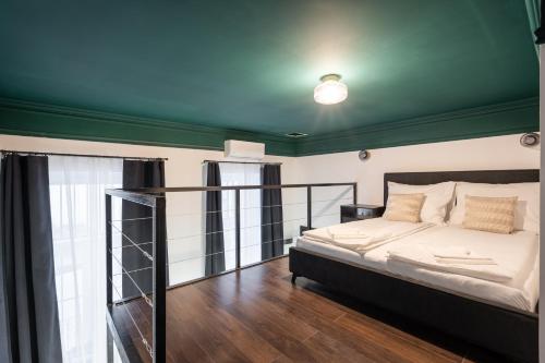 a bedroom with a bed and a green ceiling at E41 - Trendy Boutique Apartments - Prime Spot by BQA in Budapest