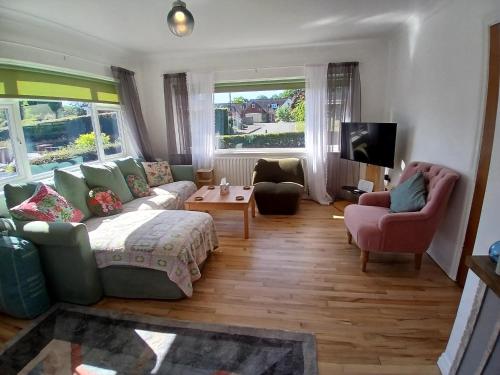 a living room with a couch and two chairs at Hillside in Ewyas Harold