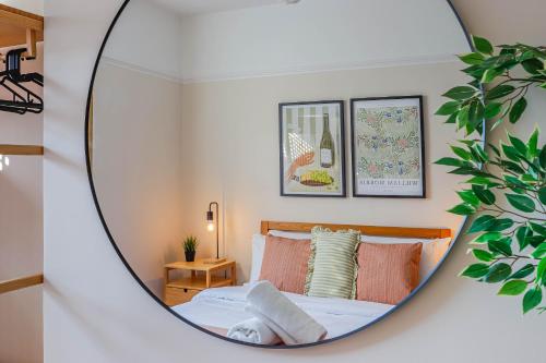 a mirror reflection of a bed in a bedroom at Georgia Suite by Koya Homes - Stylish 1BR Apartment in Barry - Wifi & Parking in Barry