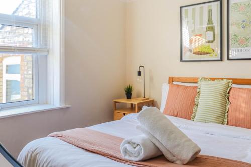 a bedroom with a bed with towels on it at Georgia Suite by Koya Homes - Stylish 1BR Apartment in Barry - Wifi & Parking in Barry