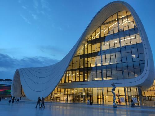 a large glass building with people in front of it at Grand Boutique Hotel in Baku
