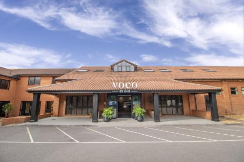 akwoco building with a parking lot in front of it at voco Corby Kettering by IHG in Corby