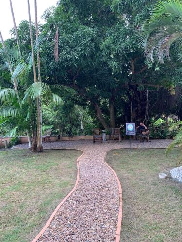 a walkway in a park with a person sitting on a bench at 806 Suite Aquarela do Poente in Manaus