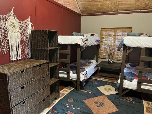 a room with three bunk beds and a window at Moz Inn - Coconut View Resort in Lopes